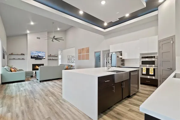 a kitchen with kitchen island a sink a stove and a refrigerator