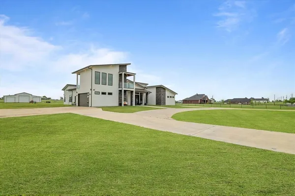 a front view of a house with a big yard
