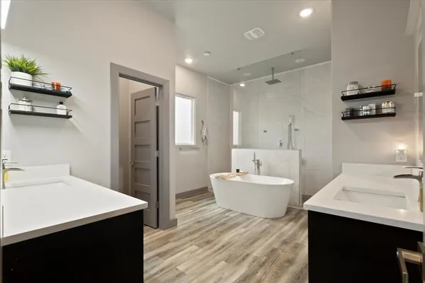 a bathroom with a sink double vanity and a bathtub
