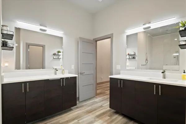 a bathroom with a double vanity sink mirror and