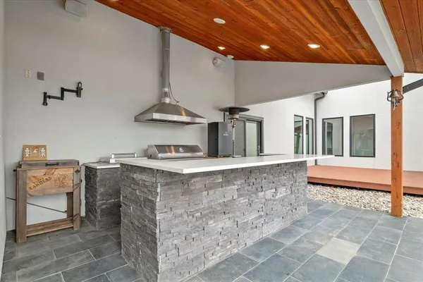 a kitchen with stainless steel appliances granite countertop a stove and a sink