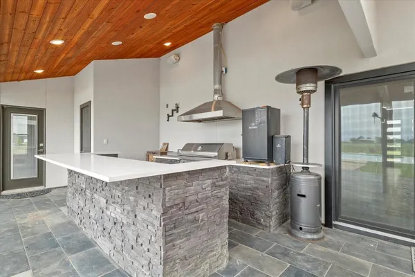 a kitchen with stainless steel appliances granite countertop a sink and a refrigerator