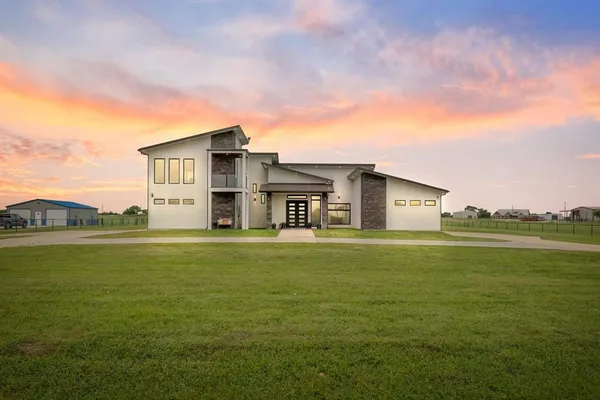 a view of a big room with a big yard and large trees