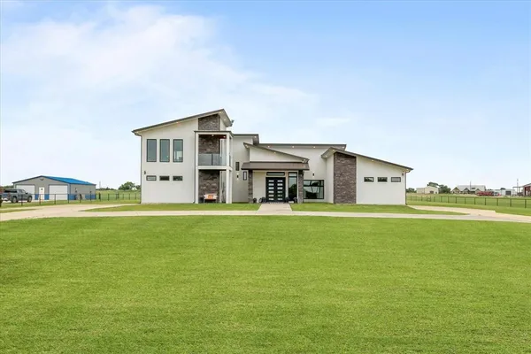 a front view of a house with a garden and deck