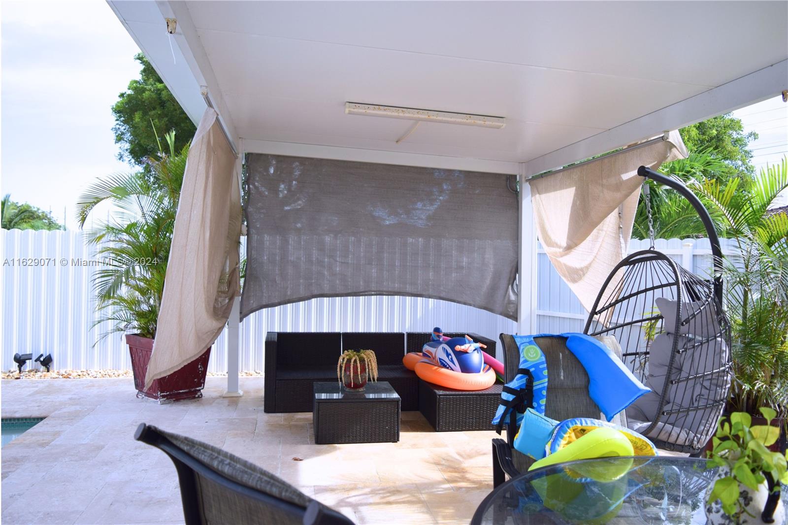 12844 Southwest 256th Terrace Homestead, FL 33032 - Photo 16 of 21 a front view of a house with outdoor seating