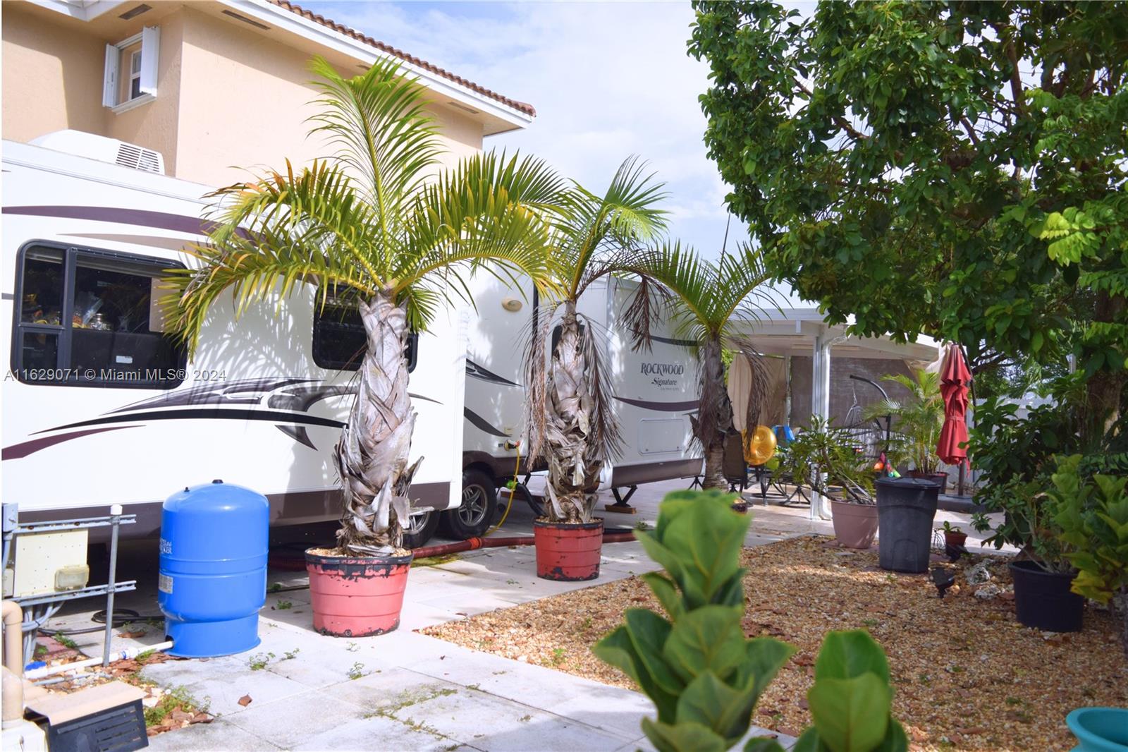12844 Southwest 256th Terrace Homestead, FL 33032 - Photo 17 of 21 a view of a patio with table and chairs potted plants