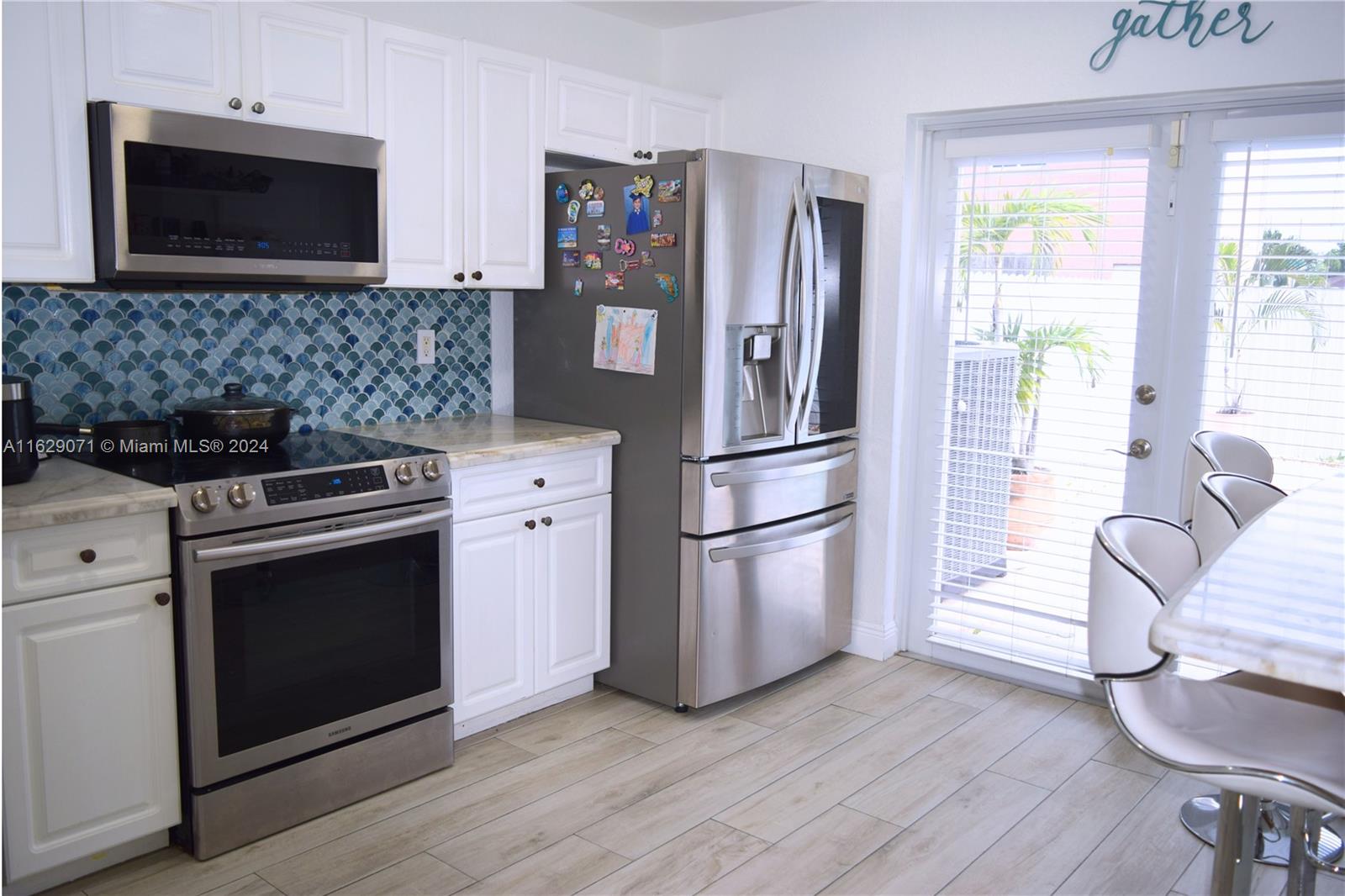 12844 Southwest 256th Terrace Homestead, FL 33032 - Photo 20 of 21 a kitchen with wooden cabinets and stainless steel appliances