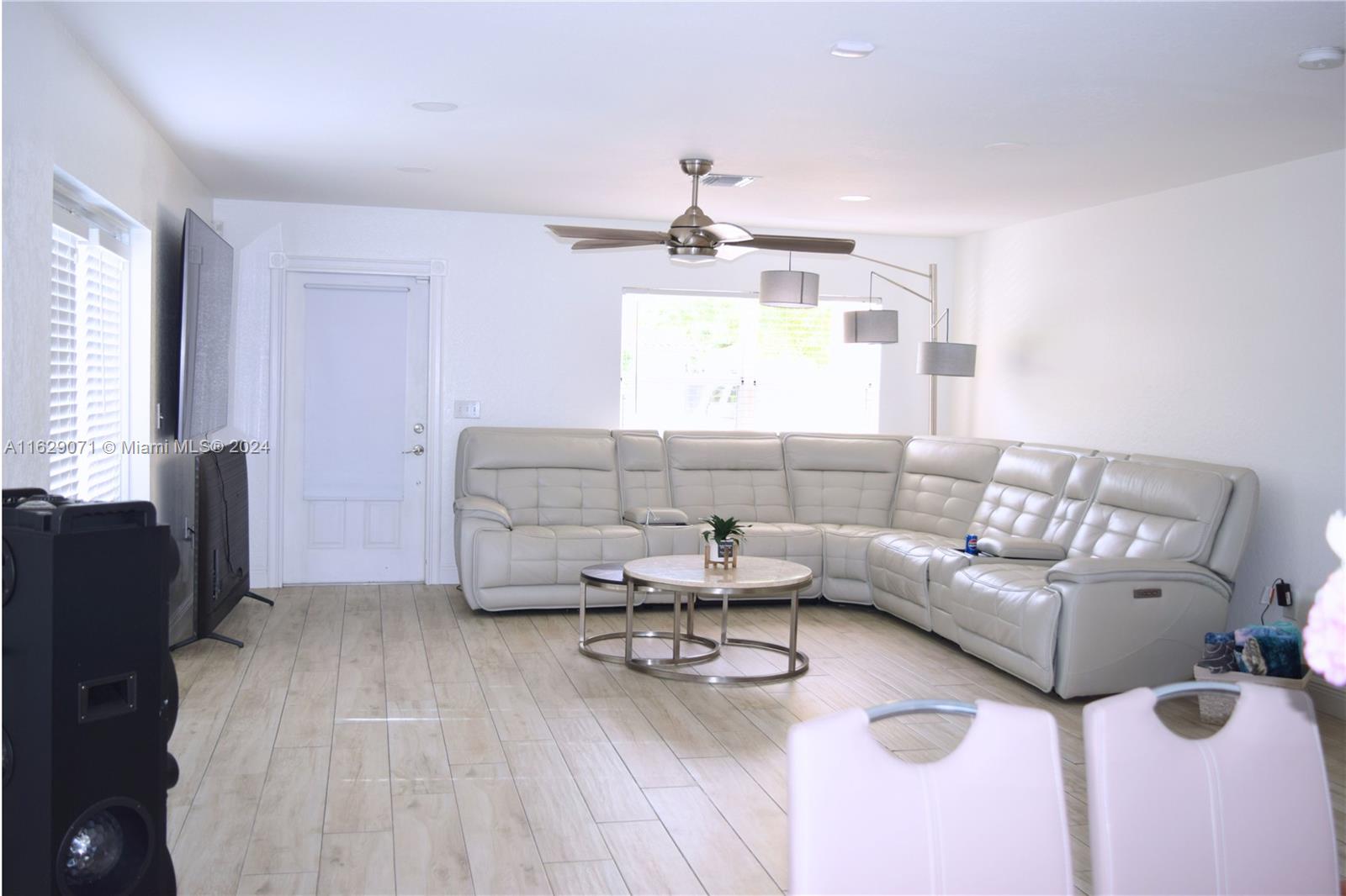 12844 Southwest 256th Terrace Homestead, FL 33032 - Photo 3 of 21 a living room with furniture and a flat screen tv