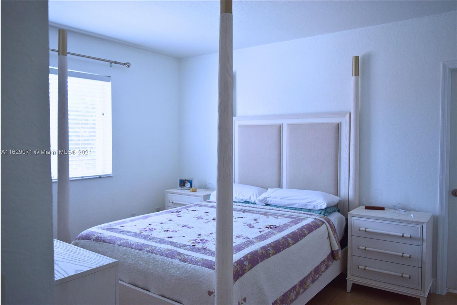 12844 Southwest 256th Terrace Homestead, FL 33032 - Photo 6 of 21 a bed room with a bed and a window