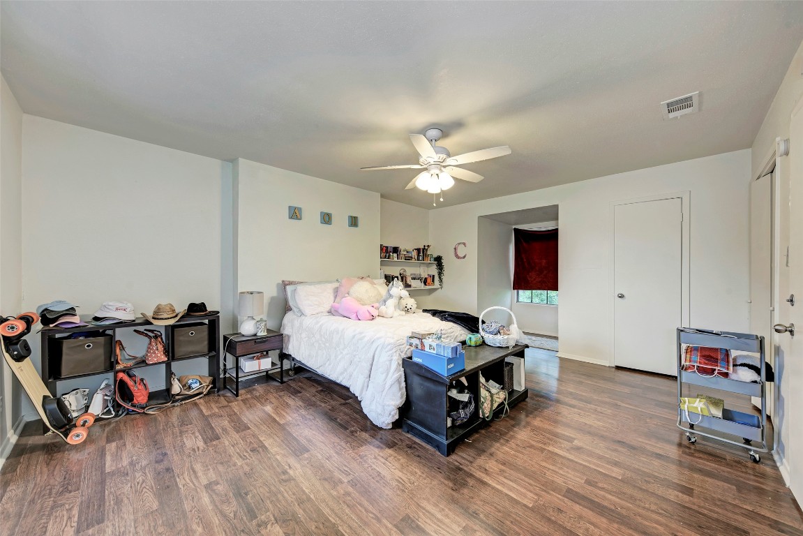 3102 Cedar Street, Unit A Austin, TX 78705 - Photo 18 of 23 a bed room with a bed and a chair