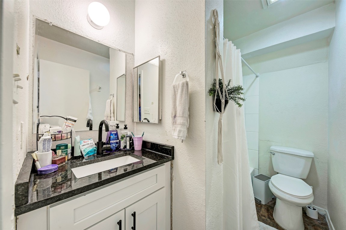 3102 Cedar Street, Unit A Austin, TX 78705 - Photo 20 of 23 a bathroom with a granite countertop sink toilet and shower