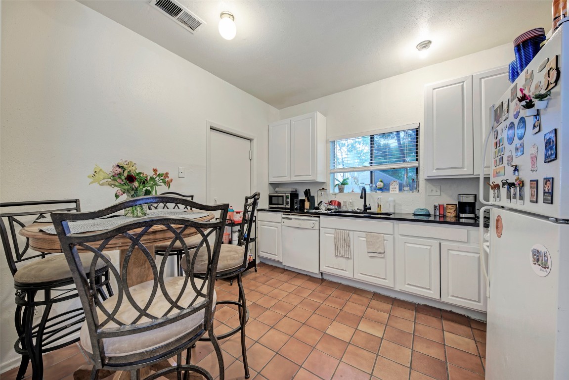 3102 Cedar Street, Unit A Austin, TX 78705 - Photo 4 of 23 a kitchen with stainless steel appliances a sink and a refrigerator