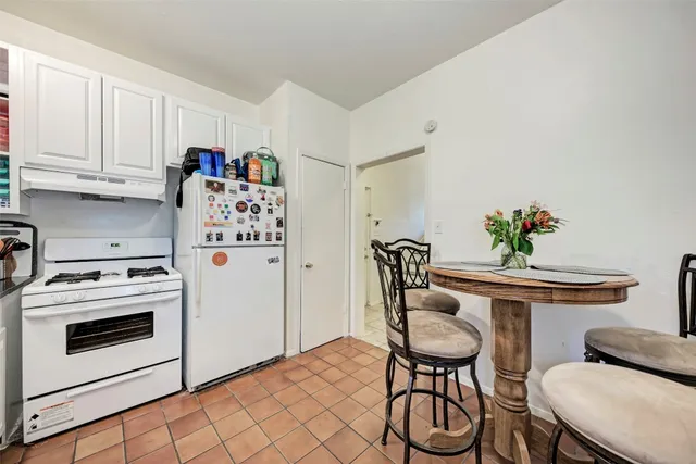 a view of a kitchen with furniture and wooden floor