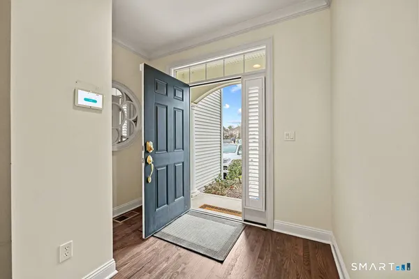 a view of a hallway with wooden floor and windows