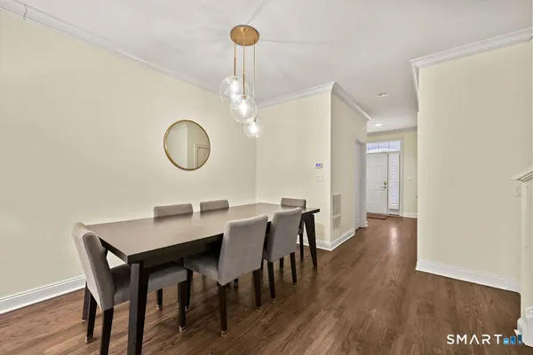 a view of a dining room with furniture and wooden floor