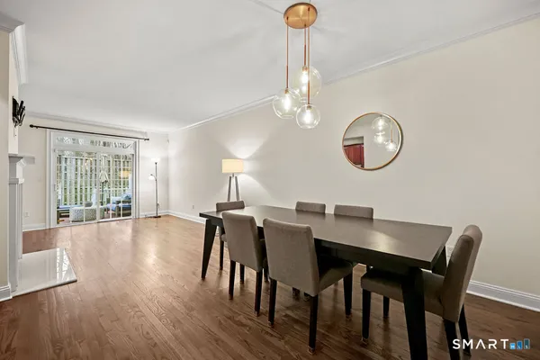 a view of a dining room with furniture window and wooden floor