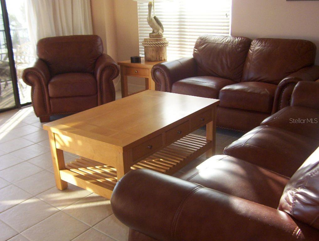 13650 Gulf Boulevard, Unit 304 Madeira Beach, FL 33708 - Photo 20 of 63 a living room with furniture and a window