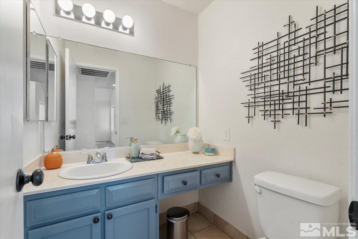 2715 Randolph Drive Reno, NV 89502 - Photo 17 of 36 a bathroom with a sink a toilet and mirror