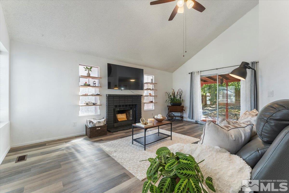 2715 Randolph Drive Reno, NV 89502 - Photo 6 of 36 a living room with furniture a flat screen tv and a fireplace