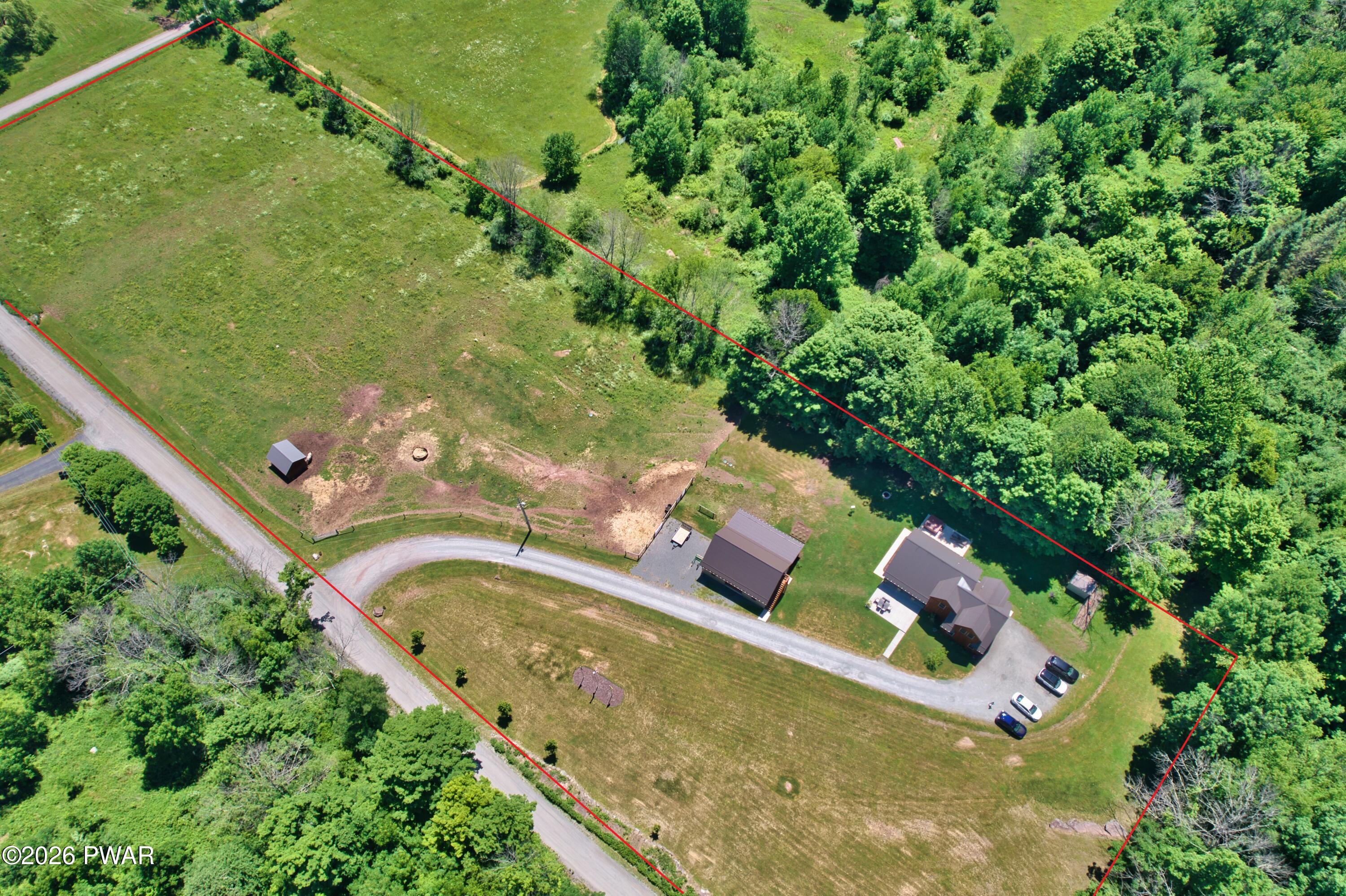 149 Sheards Road Milanville, PA 18443 - Photo 57 of 57 an aerial view of a house with a swimming pool