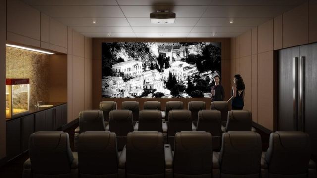 a room with furniture a window and a projector screen