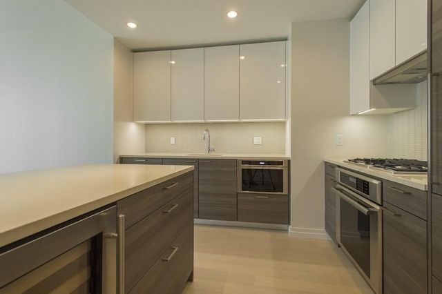 a kitchen with a stove and a refrigerator