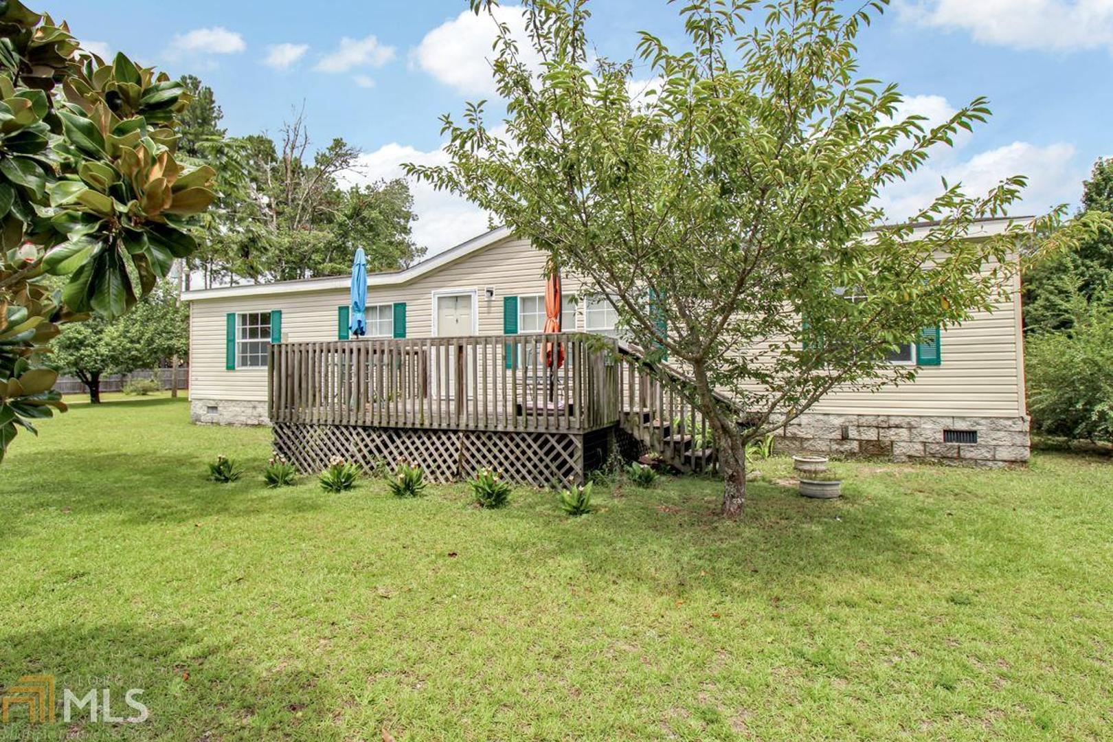 569 Hayes Lake Road Brooklet, GA 30415 - Photo 1 of 1 a white house that has a tree in front of it