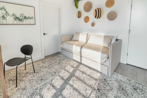 a bedroom with a bed and a chandelier
