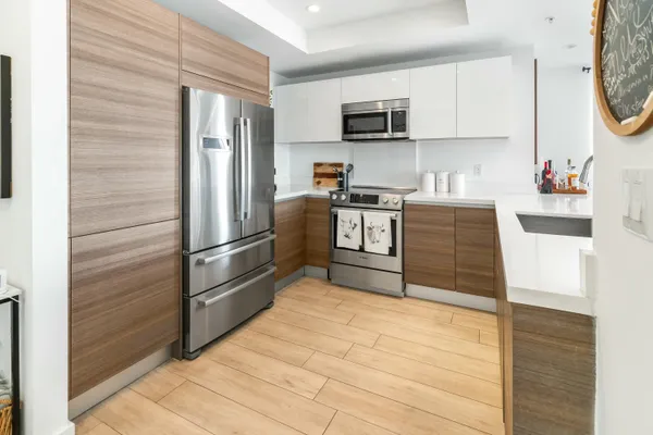 a kitchen with stainless steel appliances a refrigerator stove and microwave