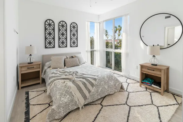 a bedroom with a bed and a mirror