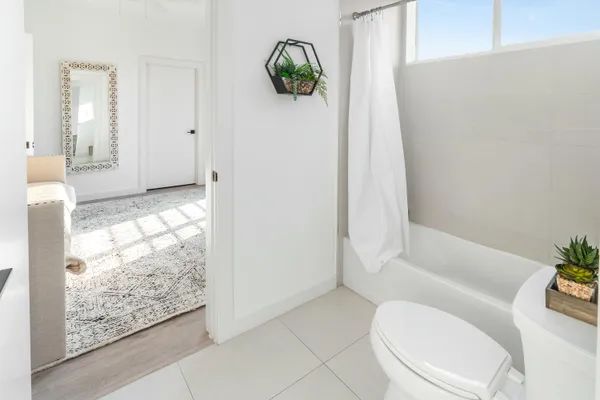 a bathroom with a toilet and shower