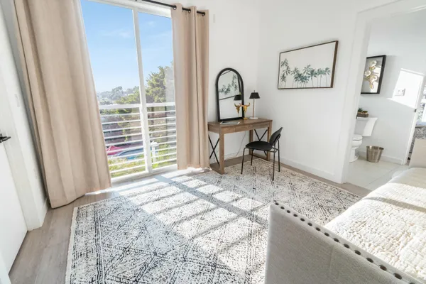 a bedroom with a bed and a table in it