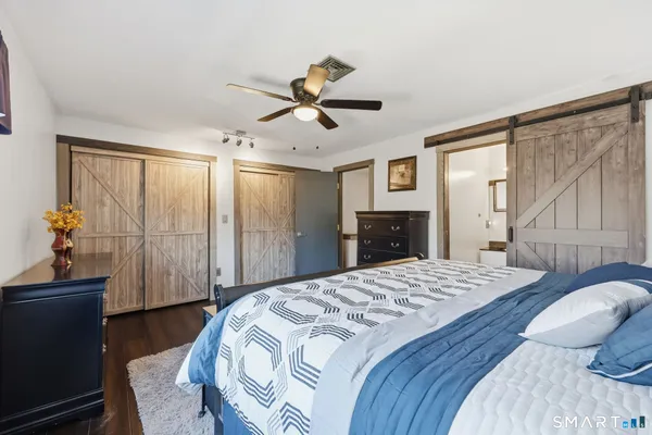 a bedroom with a large bed and a chandelier