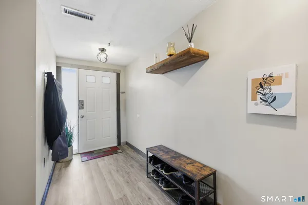 an empty room with wooden floor and a window
