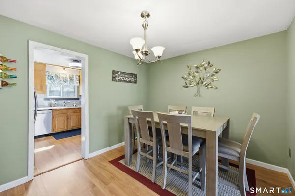 a view of a dining room with furniture and chandelier