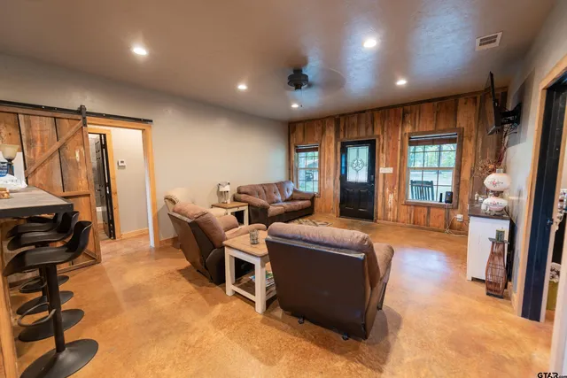 a living room with fireplace furniture and a flat screen tv