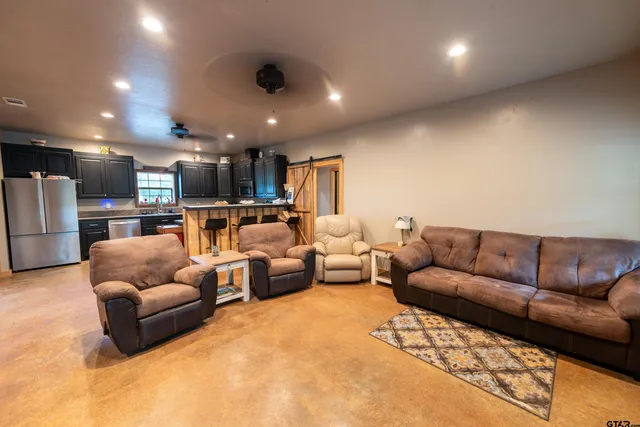 a living room with furniture and kitchen view