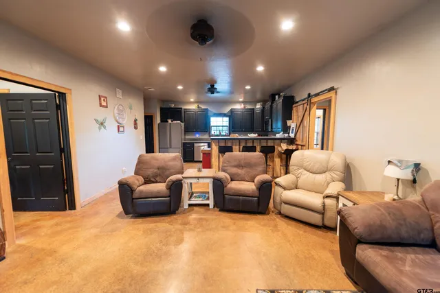 a living room with furniture and kitchen view