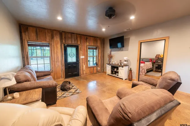 a bedroom with furniture and a window