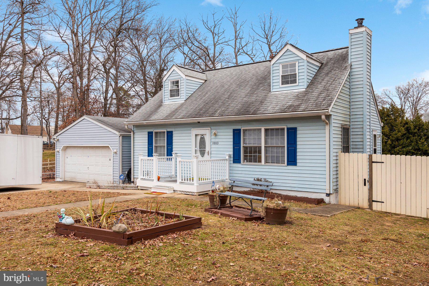1003 Lee Road Glen Burnie, MD 21061 - Photo 1 of 44 a front view of a house with a yard and garage