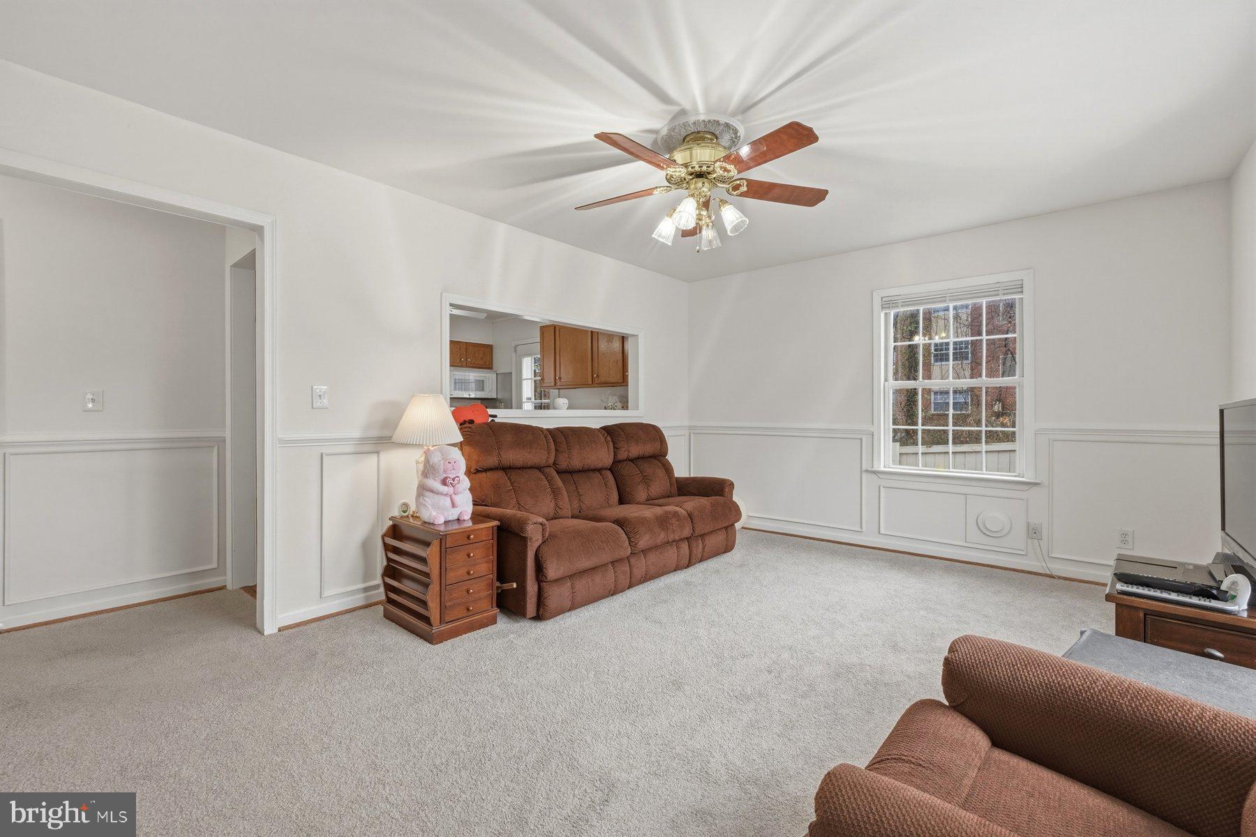 1003 Lee Road Glen Burnie, MD 21061 - Photo 13 of 44 a living room with furniture a ceiling fan and a window