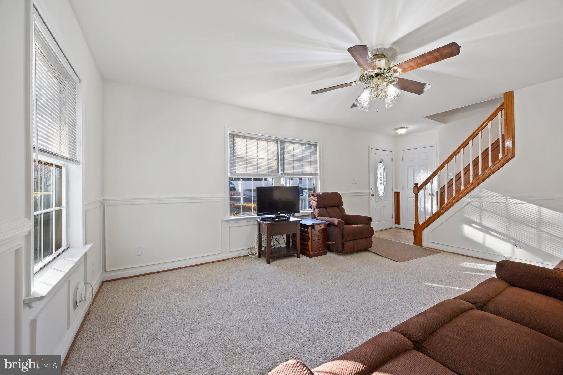 1003 Lee Road Glen Burnie, MD 21061 - Photo 14 of 44 a living room with furniture and a chandelier