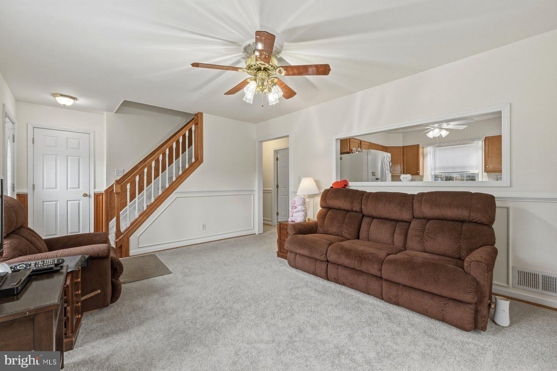1003 Lee Road Glen Burnie, MD 21061 - Photo 16 of 44 a living room with furniture and a chandelier