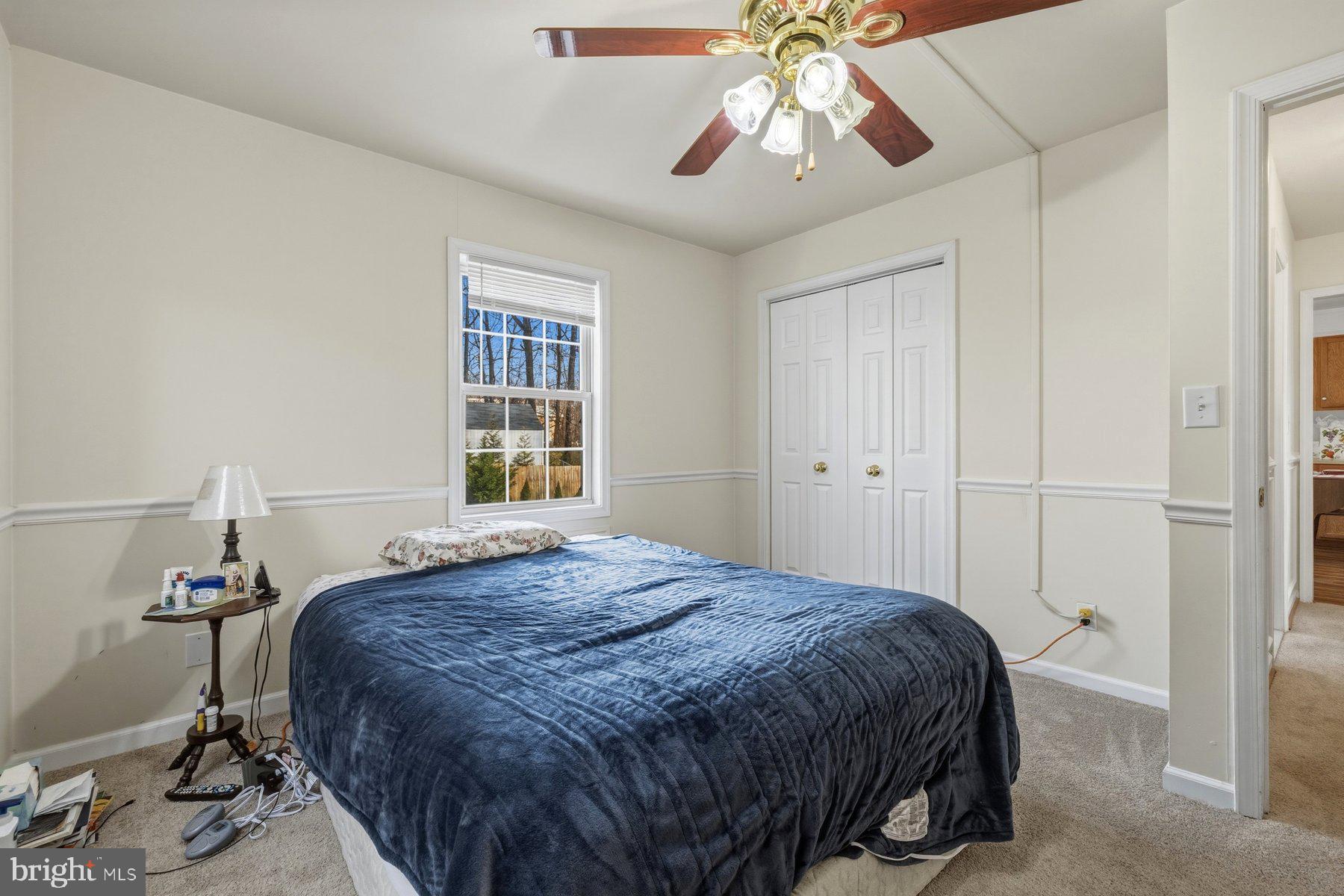 1003 Lee Road Glen Burnie, MD 21061 - Photo 18 of 44 a bedroom with a bed and a chandelier