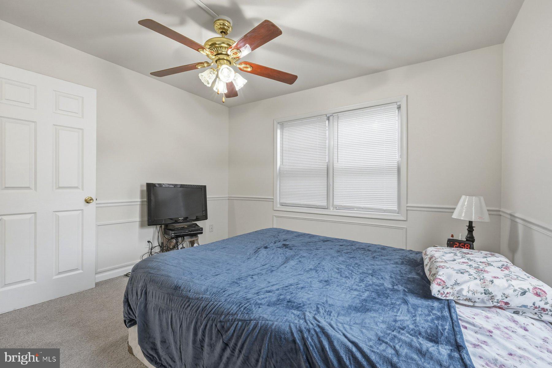 1003 Lee Road Glen Burnie, MD 21061 - Photo 20 of 44 a bedroom with a bed and a tv