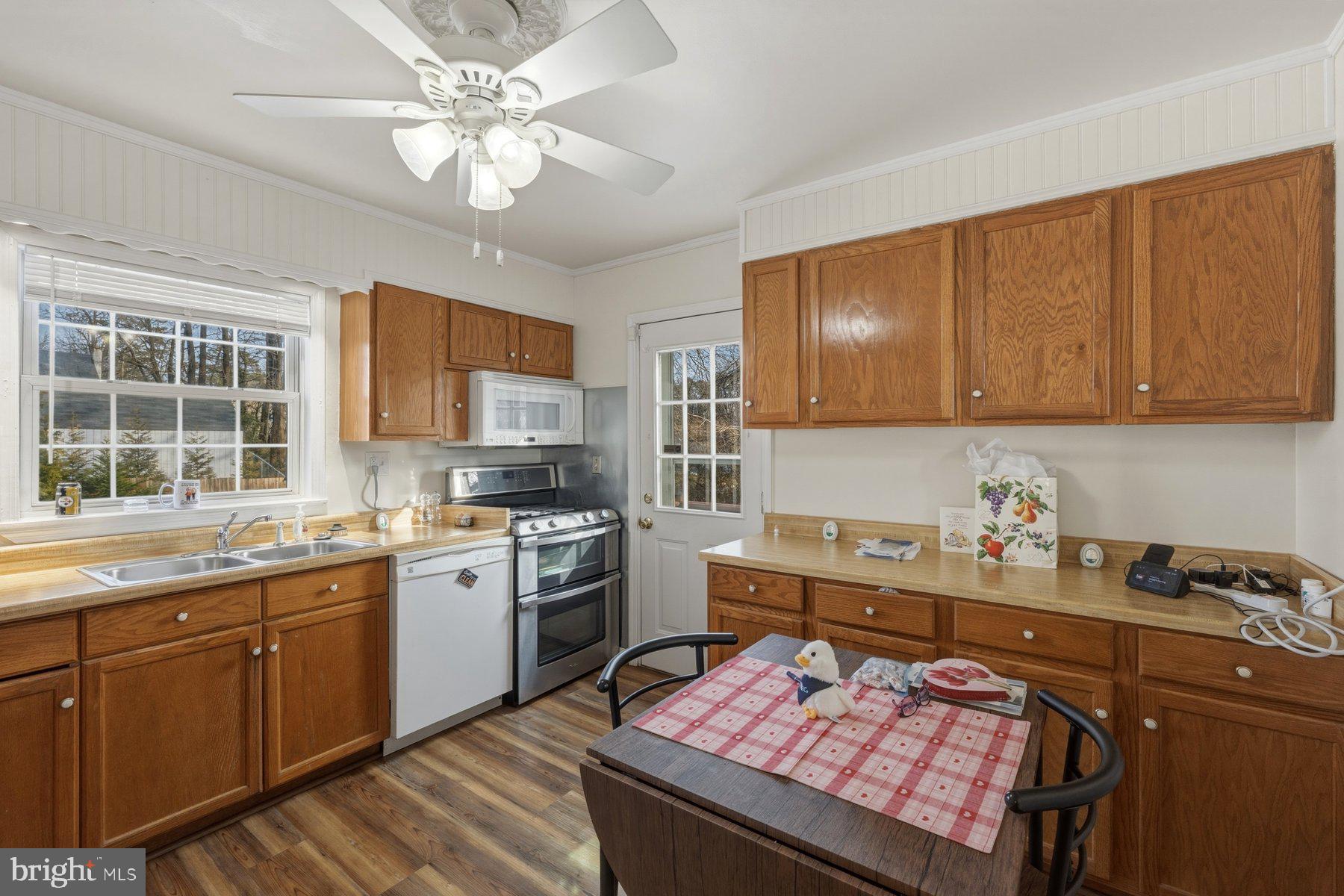 1003 Lee Road Glen Burnie, MD 21061 - Photo 3 of 44 a kitchen with a stove cabinets and window