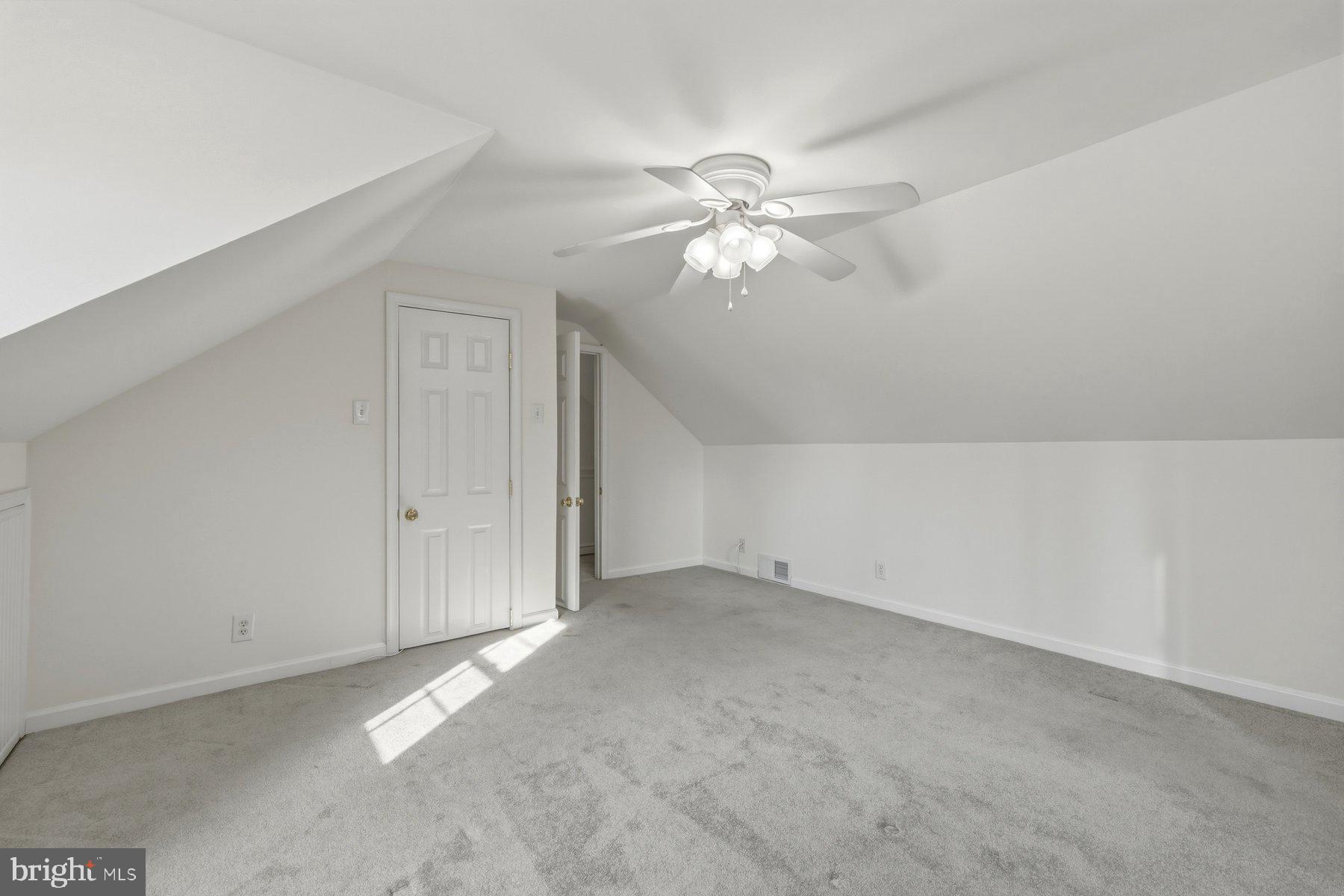 1003 Lee Road Glen Burnie, MD 21061 - Photo 31 of 44 an empty room with chandelier fan and windows