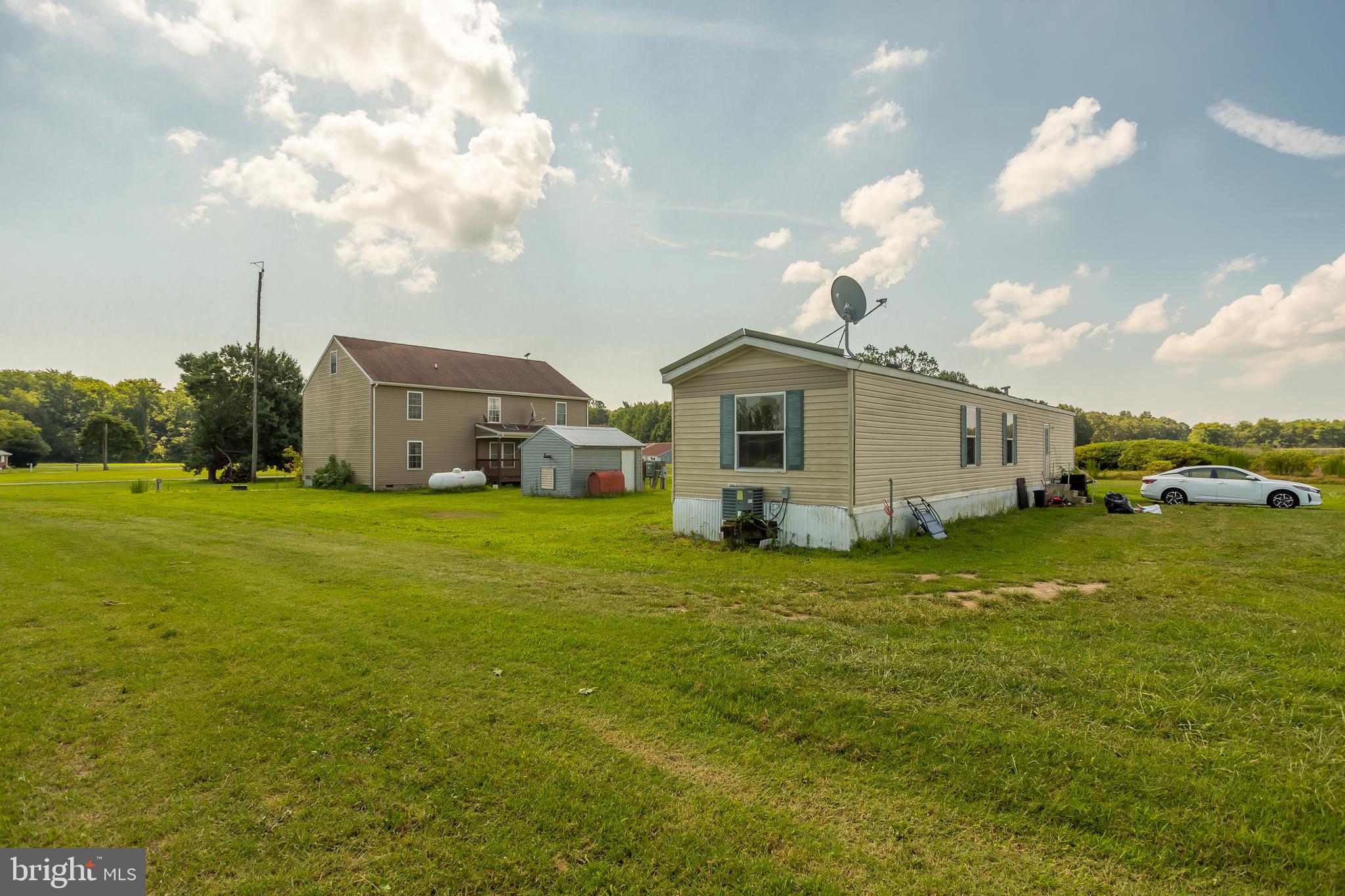 6629 Bowden Road Newark, MD 21841 - Photo 20 of 63 a front view of a house with a garden