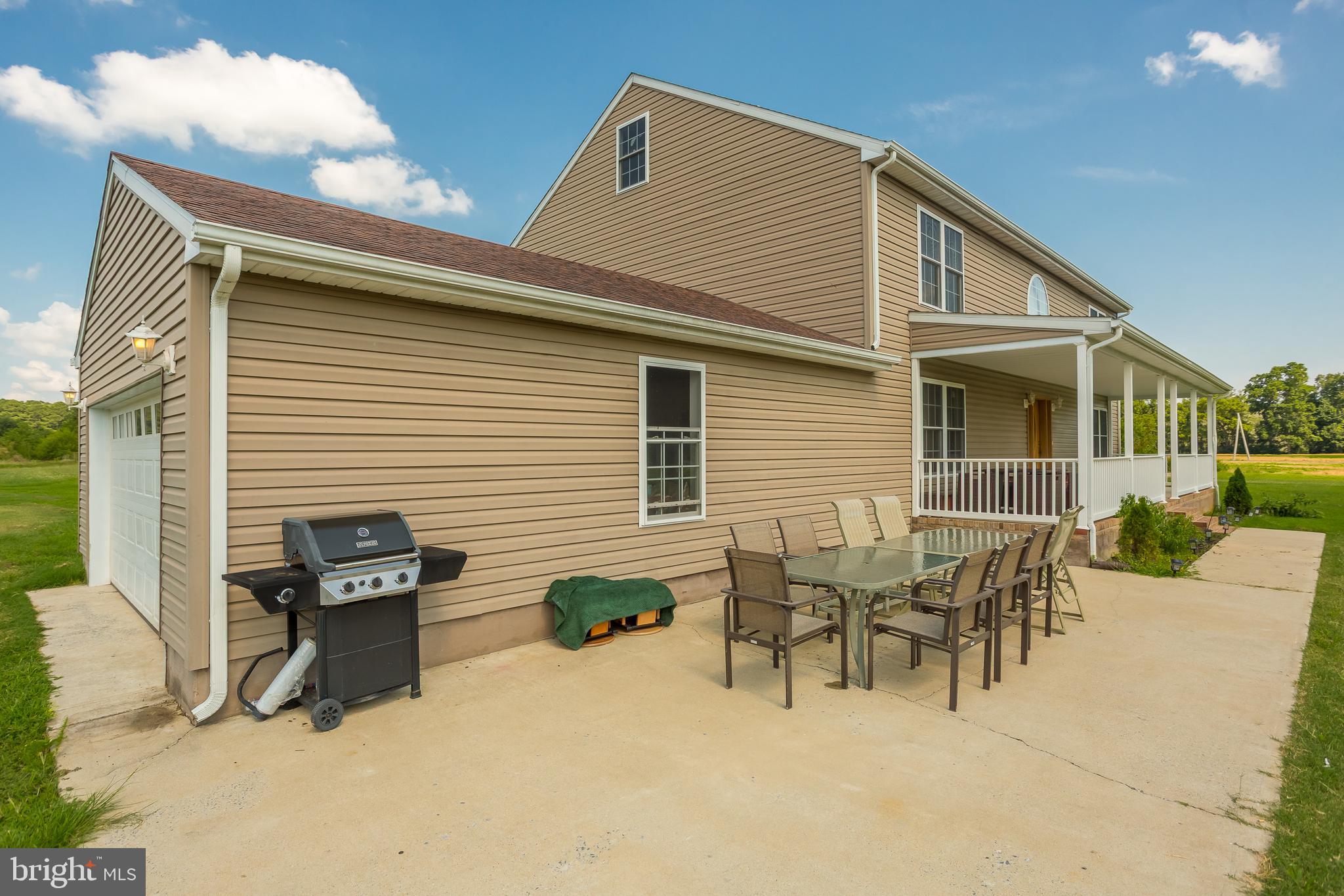 6629 Bowden Road Newark, MD 21841 - Photo 31 of 63 a backyard of a house with table and chairs