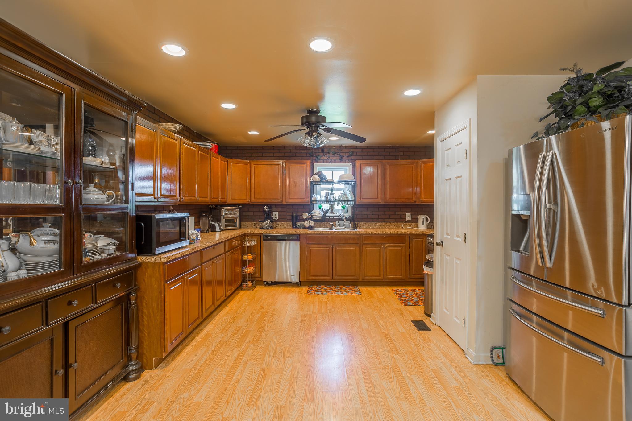 6629 Bowden Road Newark, MD 21841 - Photo 42 of 63 a large kitchen with stainless steel appliances and a refrigerator